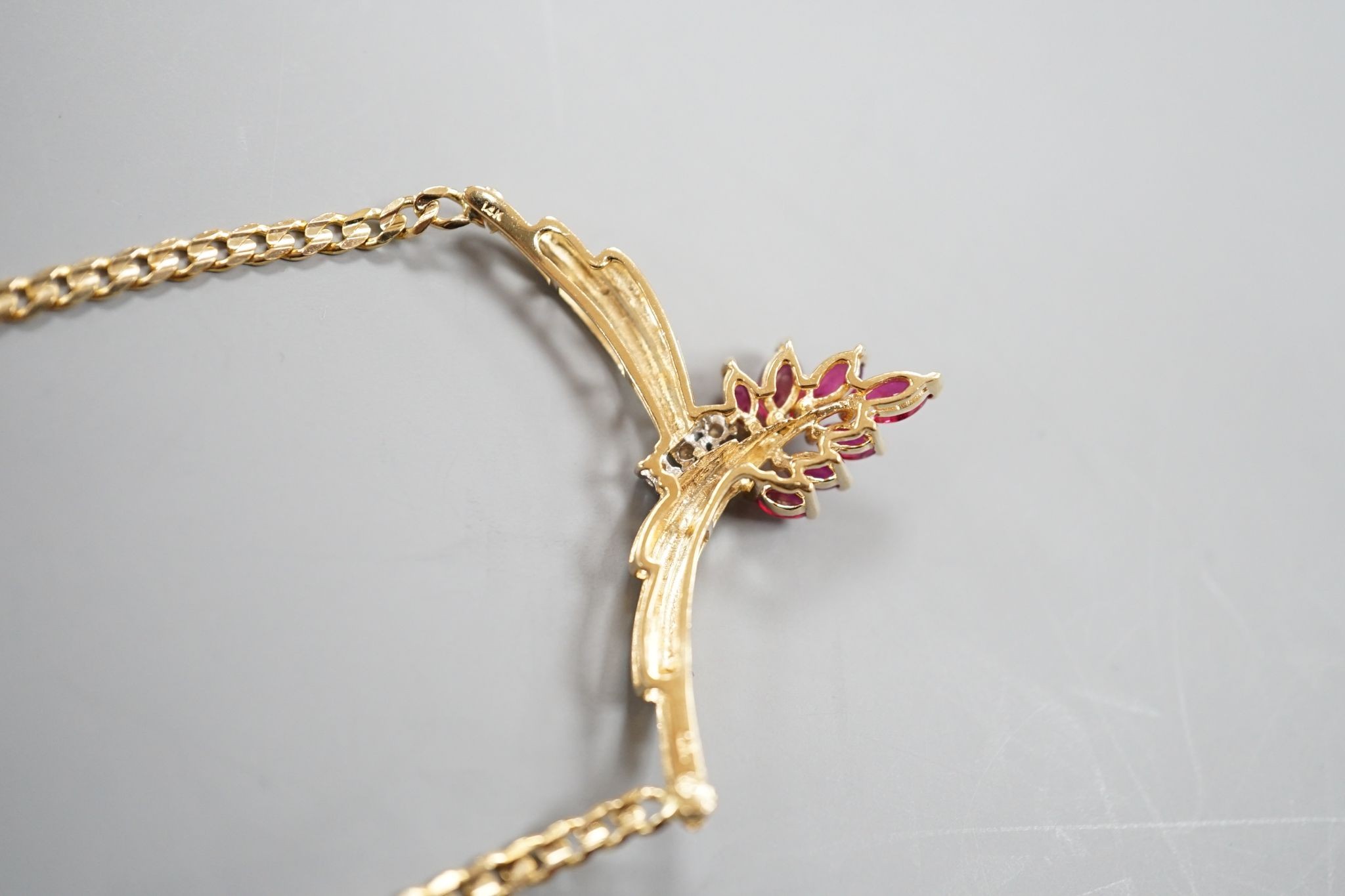 A modern 585 yellow metal, ruby and diamond cluster set pendant necklace, 44cm